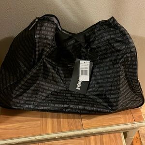 Black with Steve Madden written on it in gray large duffle bag